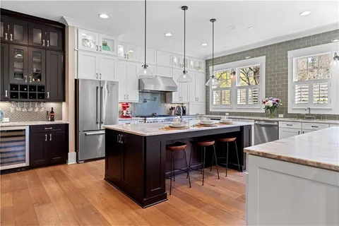 a bathroom with a granite countertop toilet a sink and a mirror