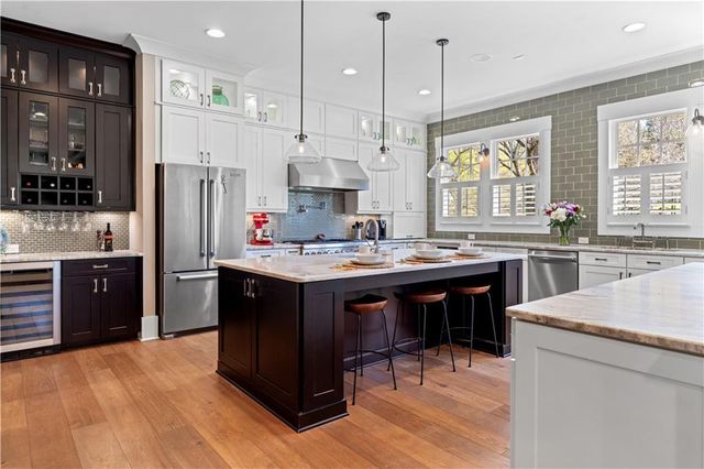 a bathroom with a granite countertop toilet a sink and a mirror