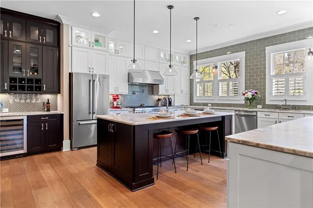 a bathroom with a granite countertop toilet a sink and a mirror
