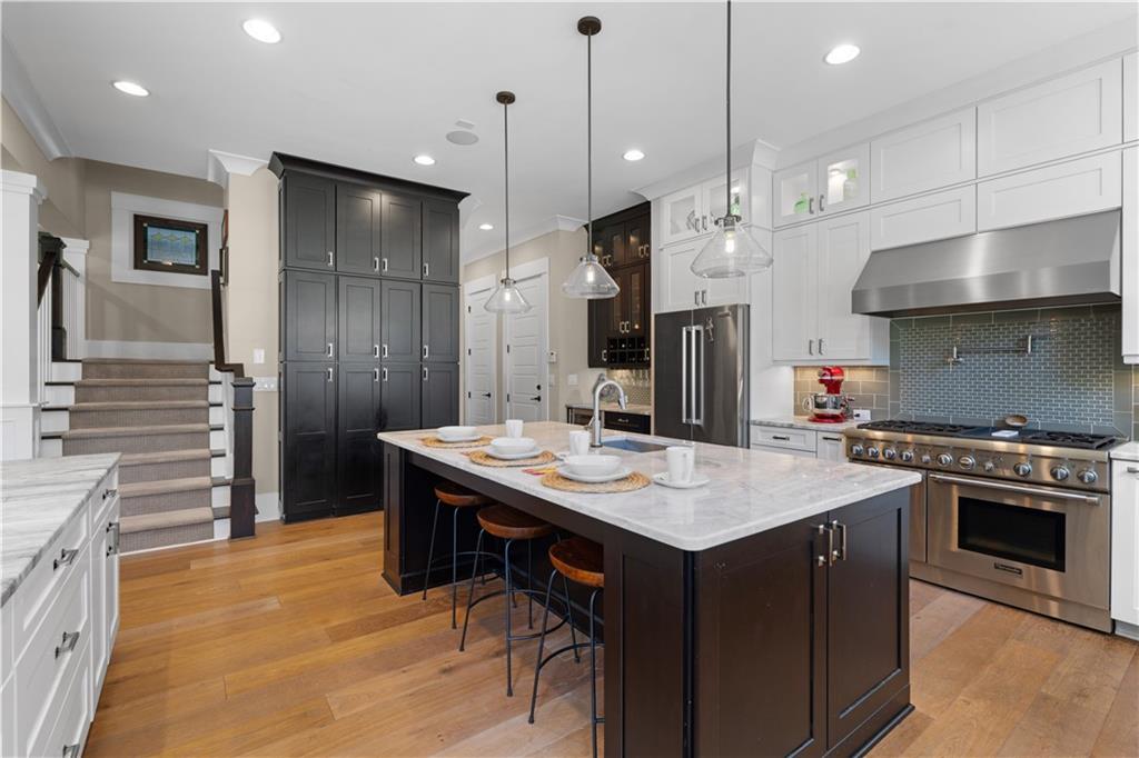 958 Austin Avenue Northeast Atlanta, GA 30307 - Photo 29 of 68 a kitchen with stainless steel appliances granite countertop a stove a refrigerator and a sink