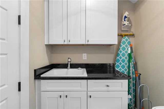 a bedroom with a bed chair and a large window