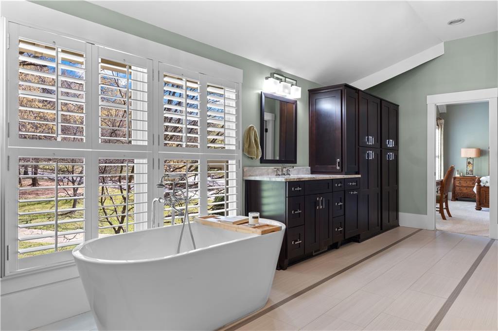 958 Austin Avenue Northeast Atlanta, GA 30307 - Photo 40 of 68 a spacious bathroom with a tub a double vanity sink a mirror and a tub