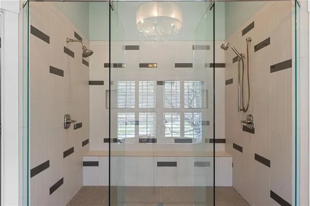 a bathroom with a tub a sink and mirror