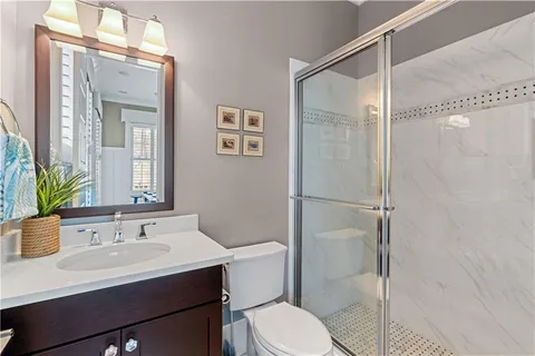 a dining room filled with furniture a chandelier and wooden floor