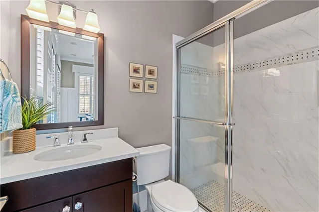a dining room filled with furniture a chandelier and wooden floor
