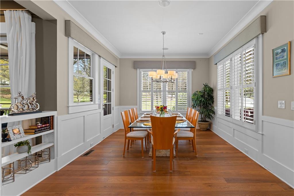 958 Austin Avenue Northeast Atlanta, GA 30307 - Photo 10 of 68 a dining room with furniture a chandelier and wooden floor