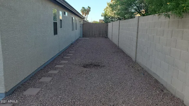 a view of a backyard with wooden fence