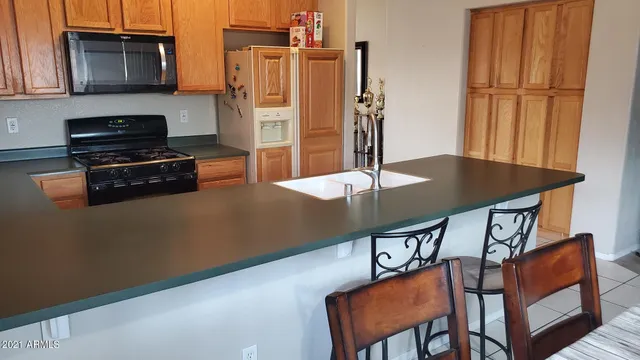 a kitchen with stainless steel appliances a stove refrigerator and microwave