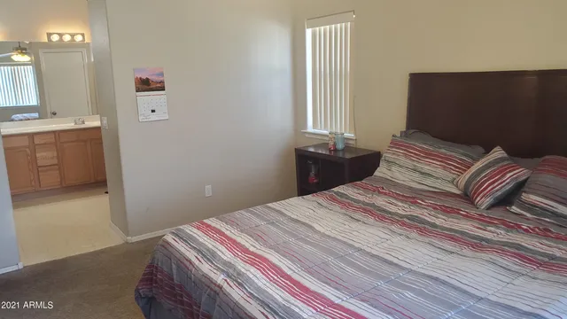 a bedroom with a bed and a dresser