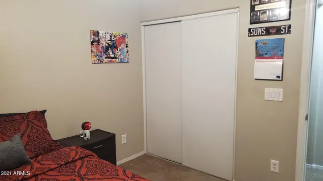 a living room with furniture and a wall painting