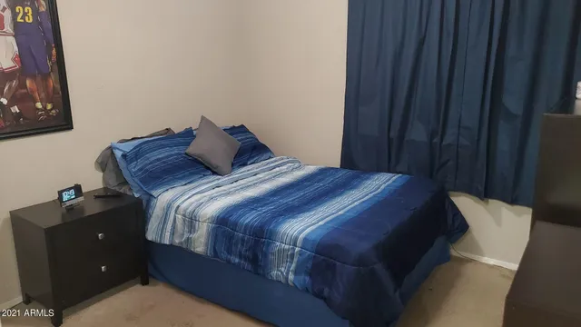 a bedroom with a bed and window