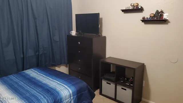 a bedroom with a bed and cabinets