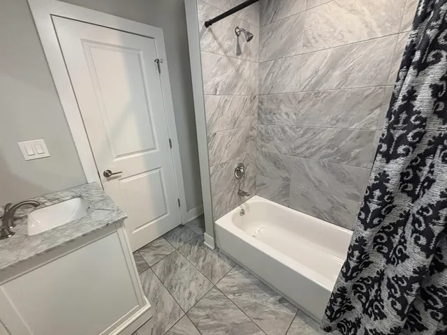 a bathroom with a tub sink and a shower