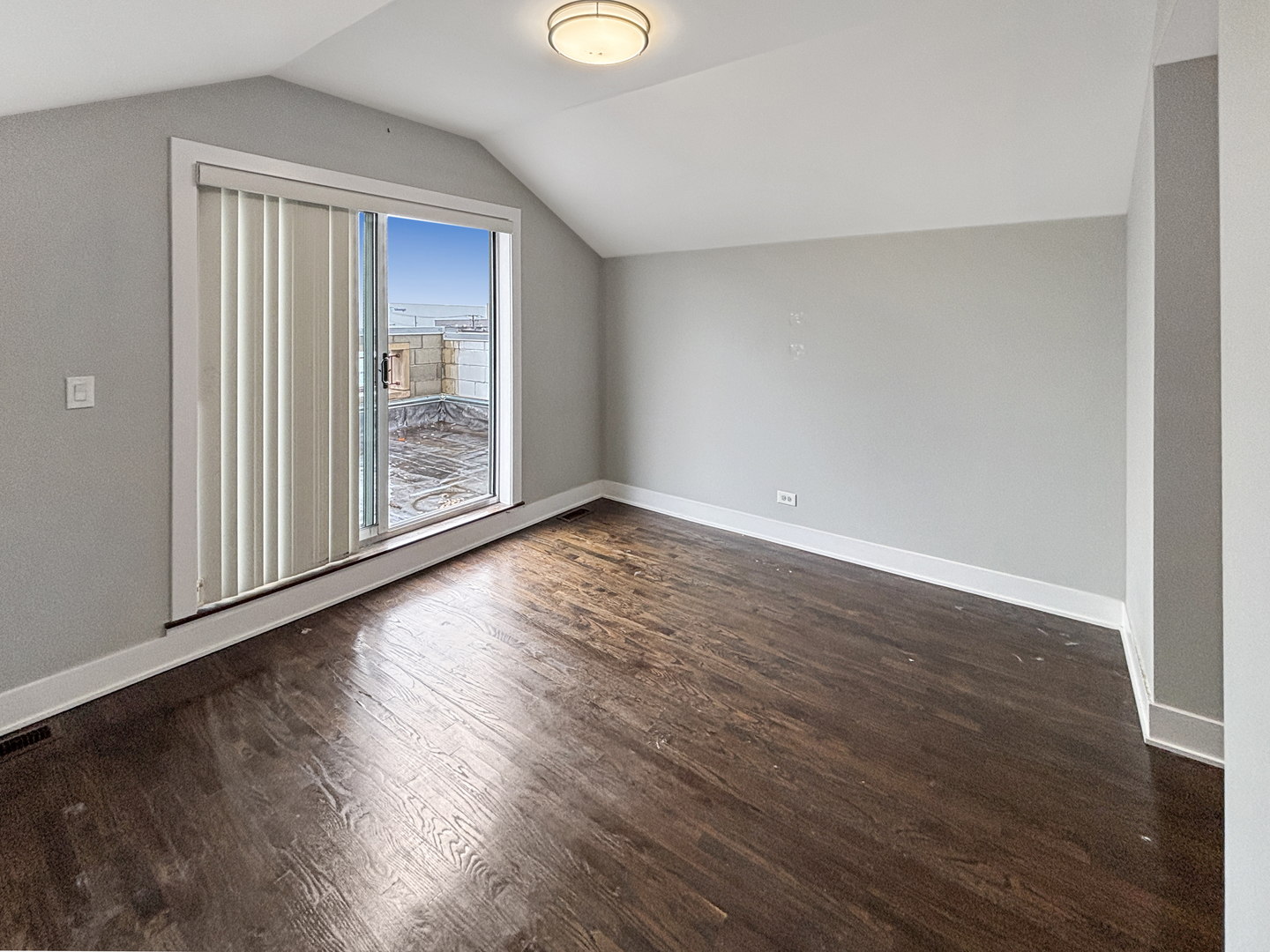 1634 West Cermak Road, Unit 3 Chicago, IL 60608 - Photo 6 of 19 a view of an empty room with wooden floor and a window