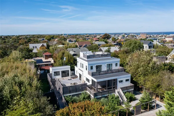 an aerial view of a house with a yard