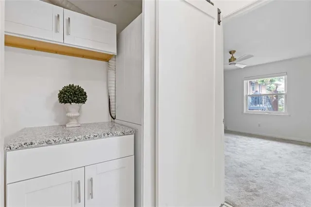 a view hallway with granite countertop cabinets