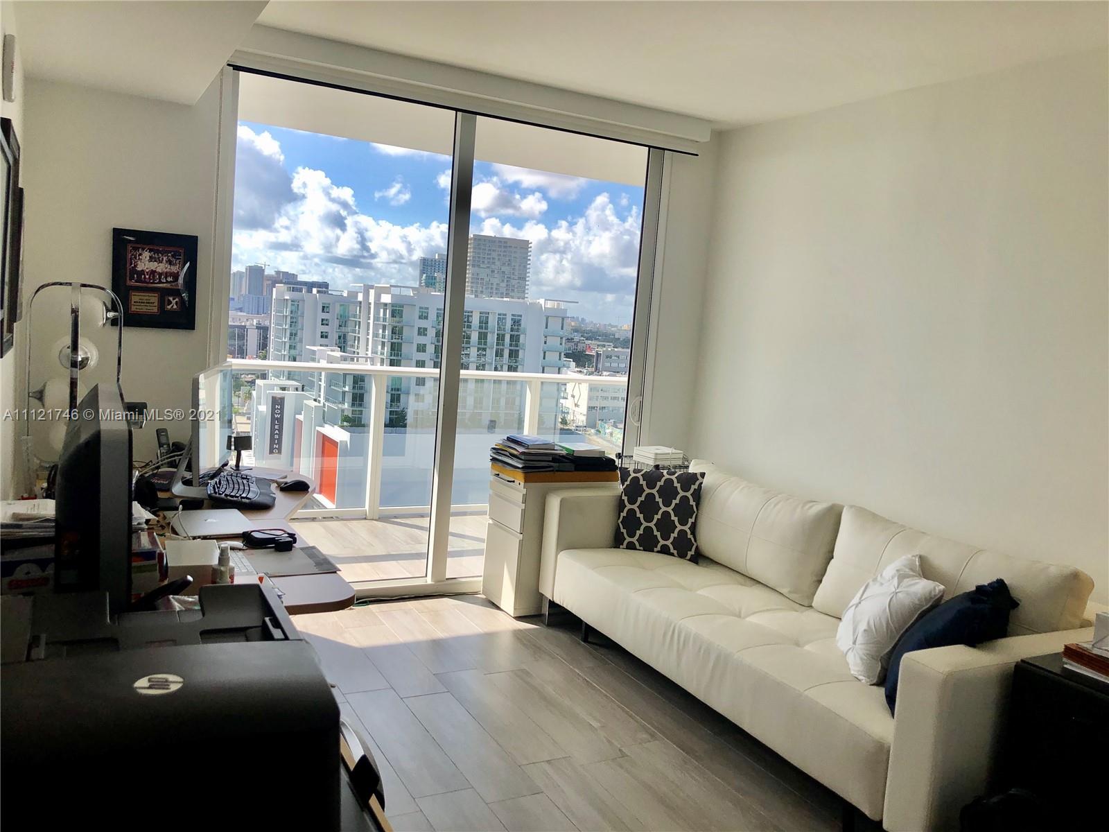 4250 Biscayne Boulevard, Unit 1601 Miami, FL 33137 - Photo 13 of 18 a living room with furniture and a flat screen tv