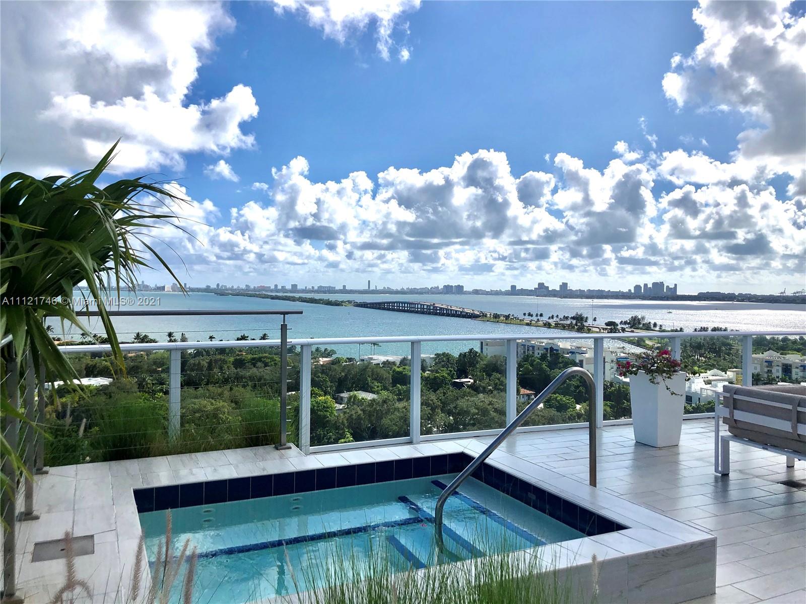 4250 Biscayne Boulevard, Unit 1601 Miami, FL 33137 - Photo 17 of 18 a view of a swimming pool with outdoor seating and plants