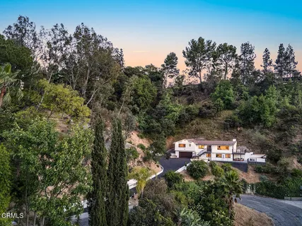 an aerial view of a house with yard and outdoor seating