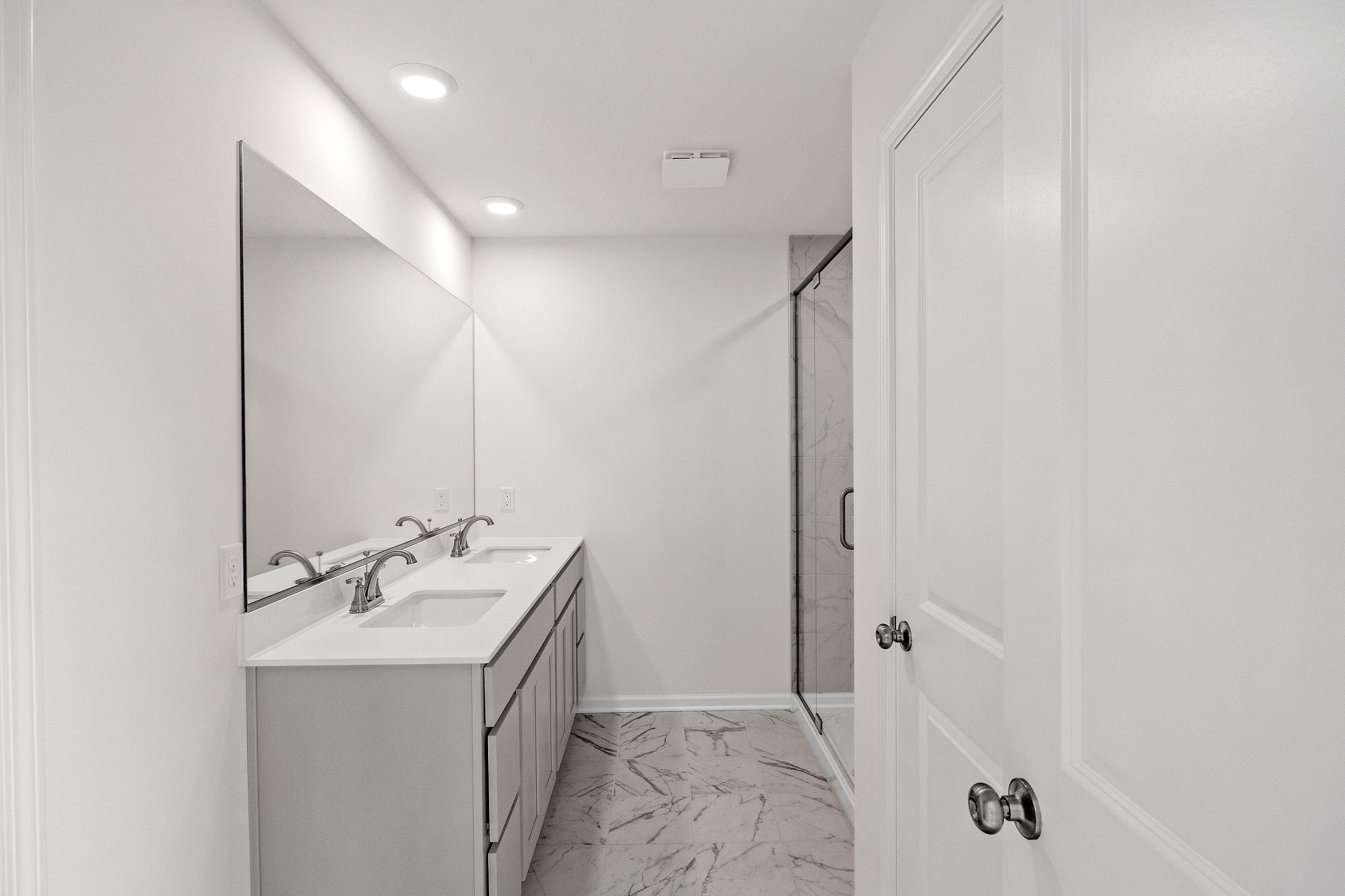 11031 Delta Drive Dyer, IN 46311 - Photo 17 of 24 a bathroom with a double vanity sink and mirror