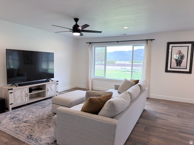 3607 South Parkinson Road South Franklin, ID 83237 - Photo 2 of 24 Living room featuring dark wood-style flooring, ceiling fan, and a mountain view