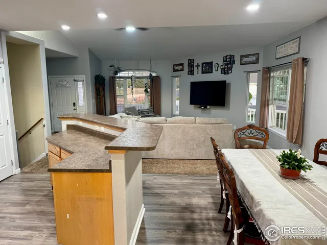 a living room with kitchen island furniture and a flat screen tv
