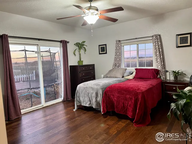 a spacious bedroom with a bed and a potted plant