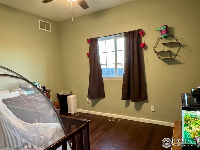 a living room with a bed furniture and a window