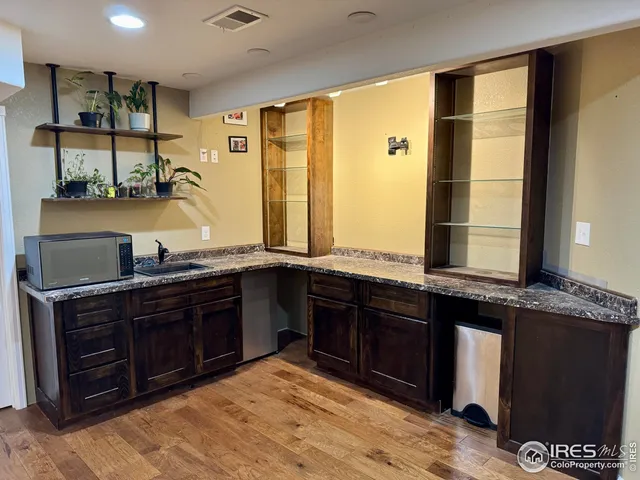 a spacious bathroom with a granite countertop sink and a large mirror