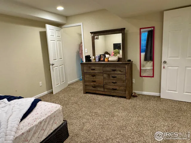 a bed room with a bed and a mirror