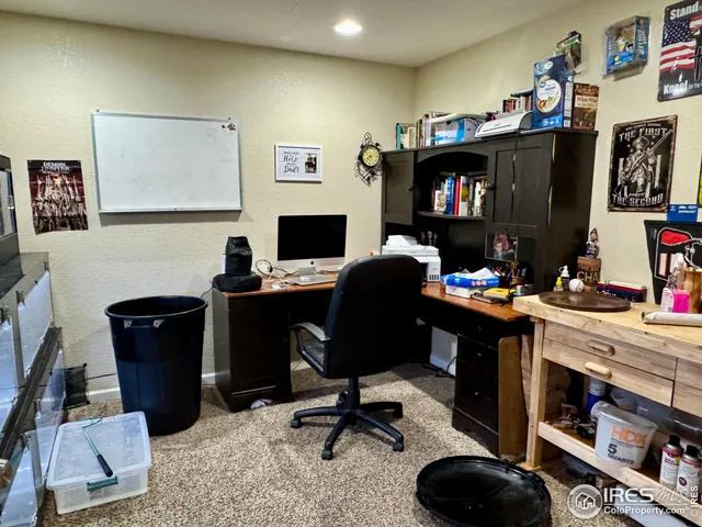 a view of a workspace with furniture and cabinet