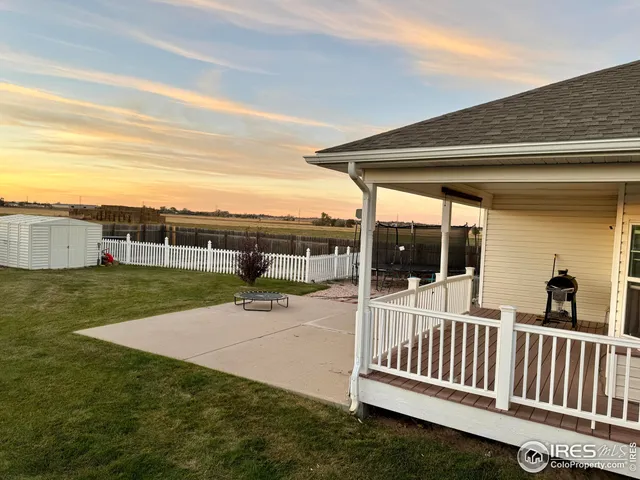 a view of a porch with furniture and garden