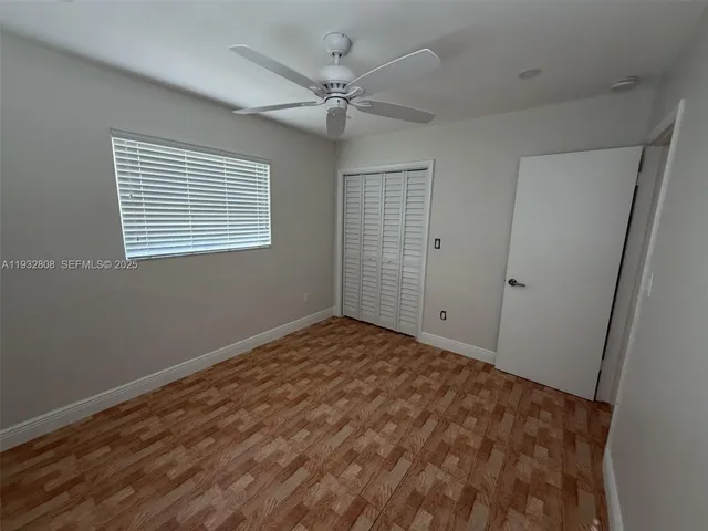 a view of a livingroom with a ceiling fan and window