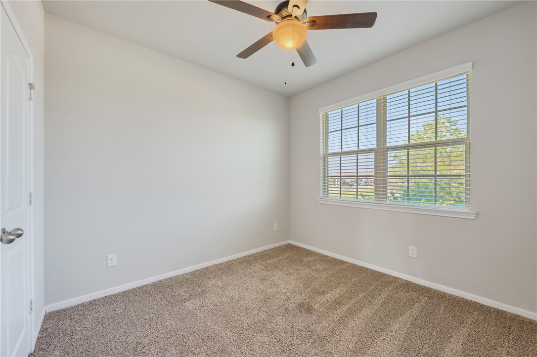 1700 Eagle View Drive Navasota, TX 77868 - Photo 12 of 22 an empty room with a window and a fan