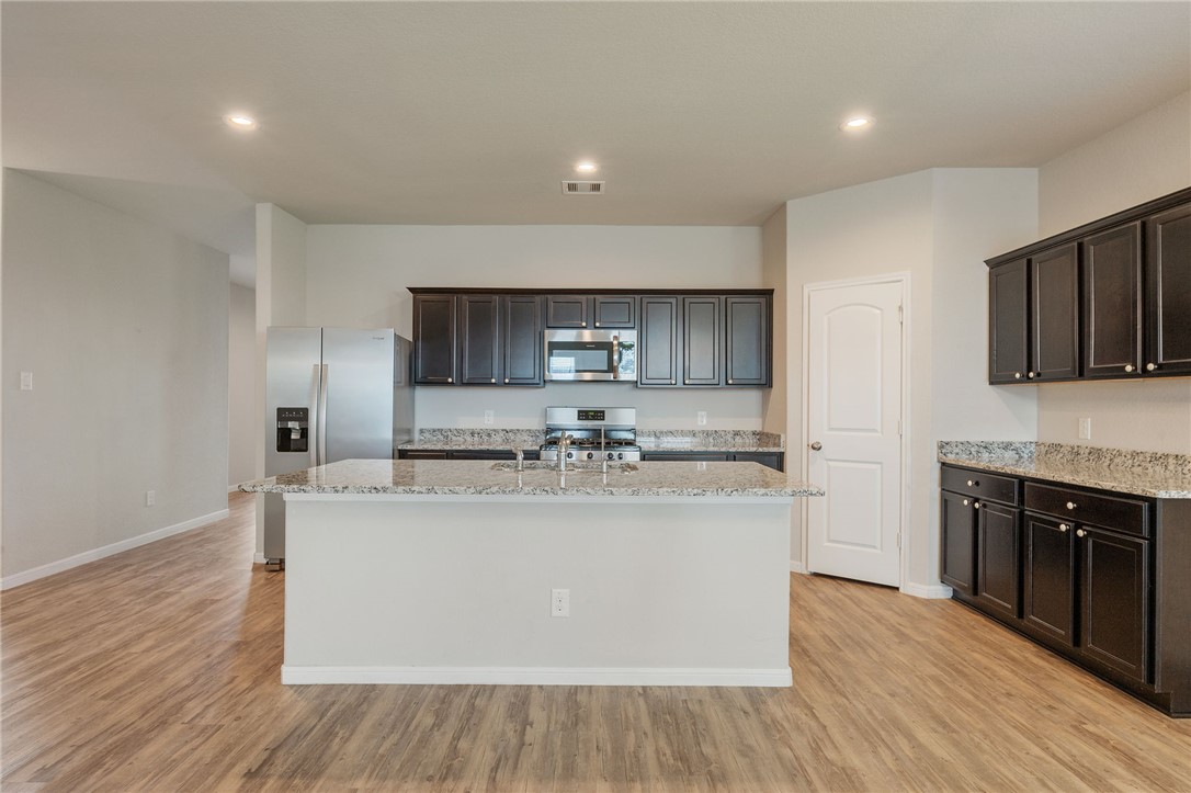 1700 Eagle View Drive Navasota, TX 77868 - Photo 2 of 22 a view of a kitchen with kitchen island a sink wooden floor and counter top space