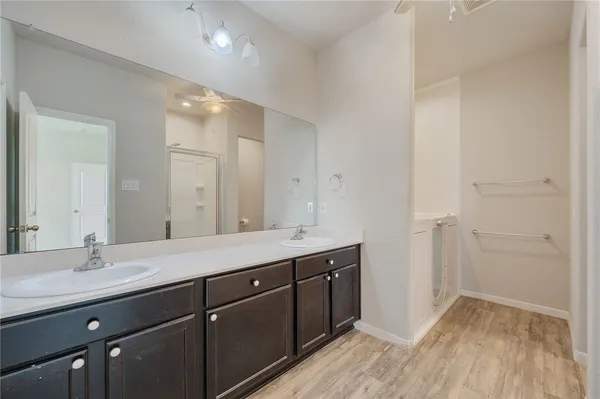 a bathroom with a double vanity sink and mirror