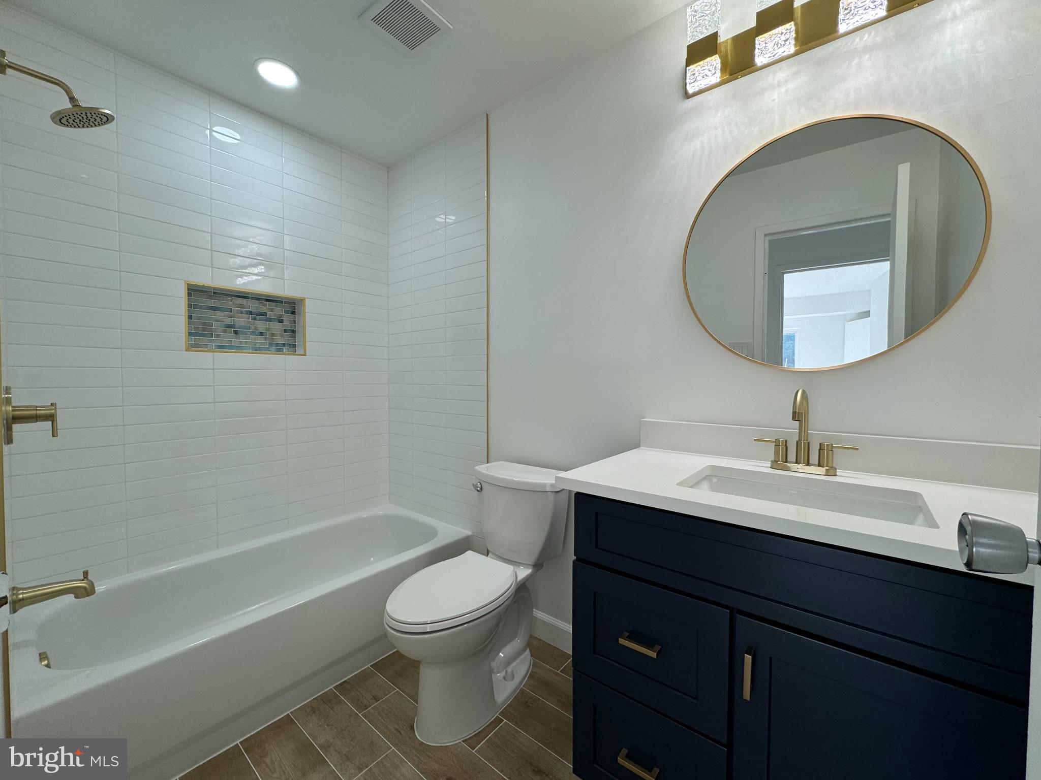 6135 Edsall Road, Unit N Alexandria, VA 22304 - Photo 5 of 9 a bathroom with a toilet sink vanity tub and mirror