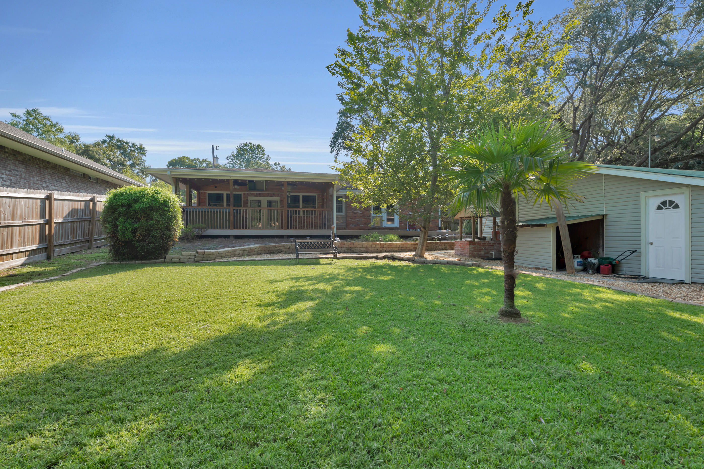 4 Roundabend Road Shalimar, FL 32579 - Photo 4 of 39 a view of a house with a backyard and a patio