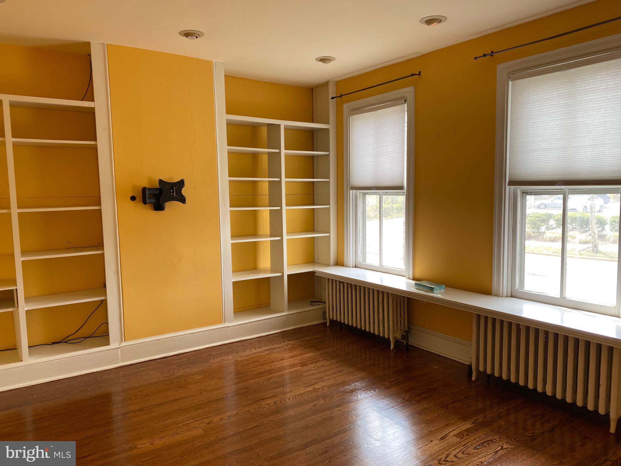 17 Walnut Street Haddonfield, NJ 08033 - Photo 2 of 9 a view of an empty room with wooden floor and a window