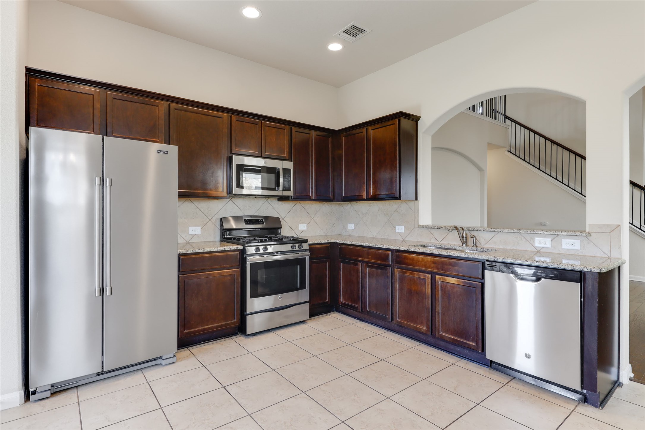 18705 Moreto Loop Pflugerville, TX 78660 - Photo 9 of 21 Culinary creations come to life in this kitchen, featuring ample cabinetry and a convenient pass-through to the living area.