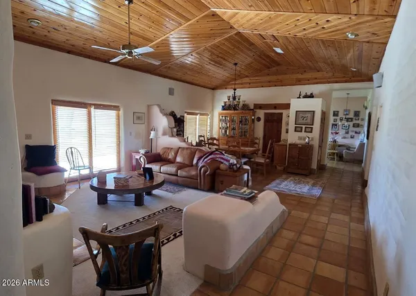 a living room with lots of furniture and a chandelier