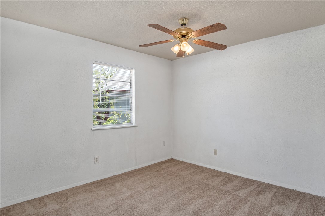 1501 Alpine Circle, Unit B College Station, TX 77840 - Photo 7 of 7 an empty room with window and chandelier fan
