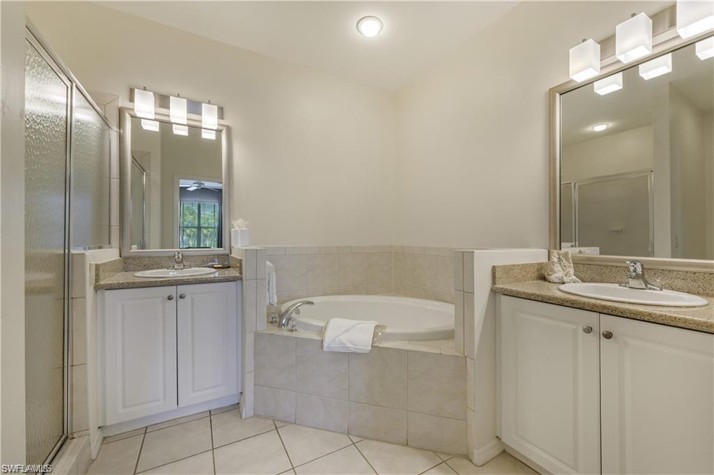 7940 Mahogany Run Lane, Unit 623 Naples, FL 34113 - Photo 13 of 25 a bathroom with a sink a toilet and mirror