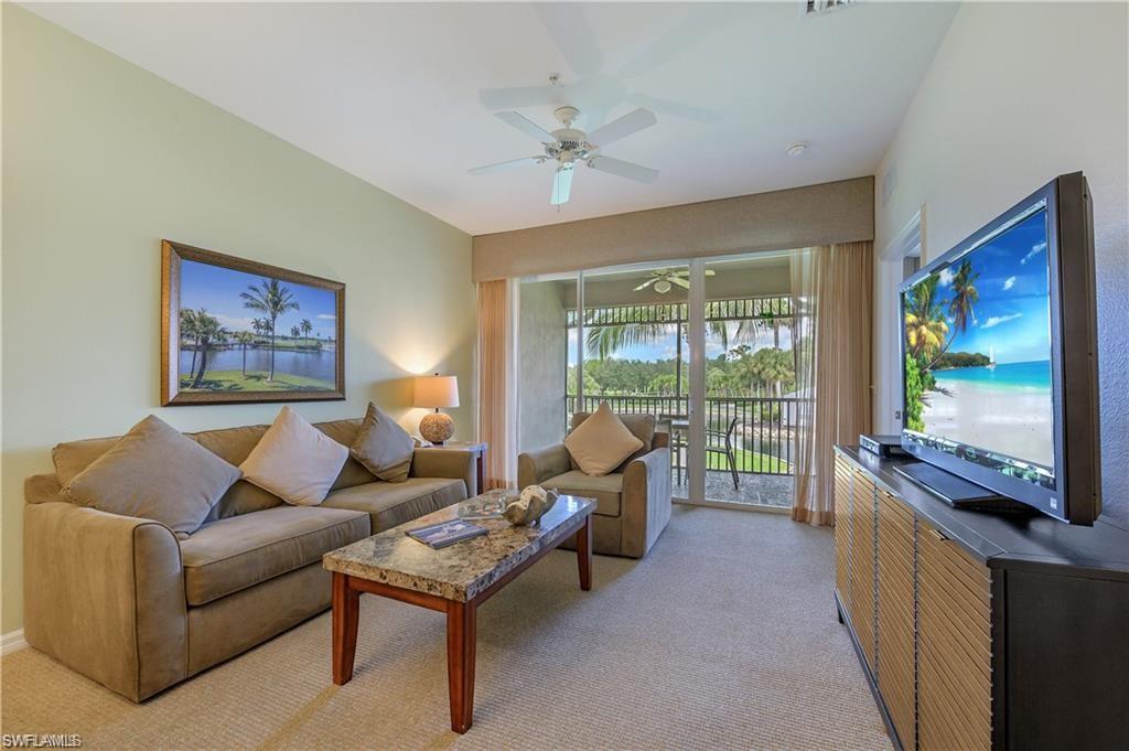 7940 Mahogany Run Lane, Unit 623 Naples, FL 34113 - Photo 4 of 25 a living room with furniture tv and a large window