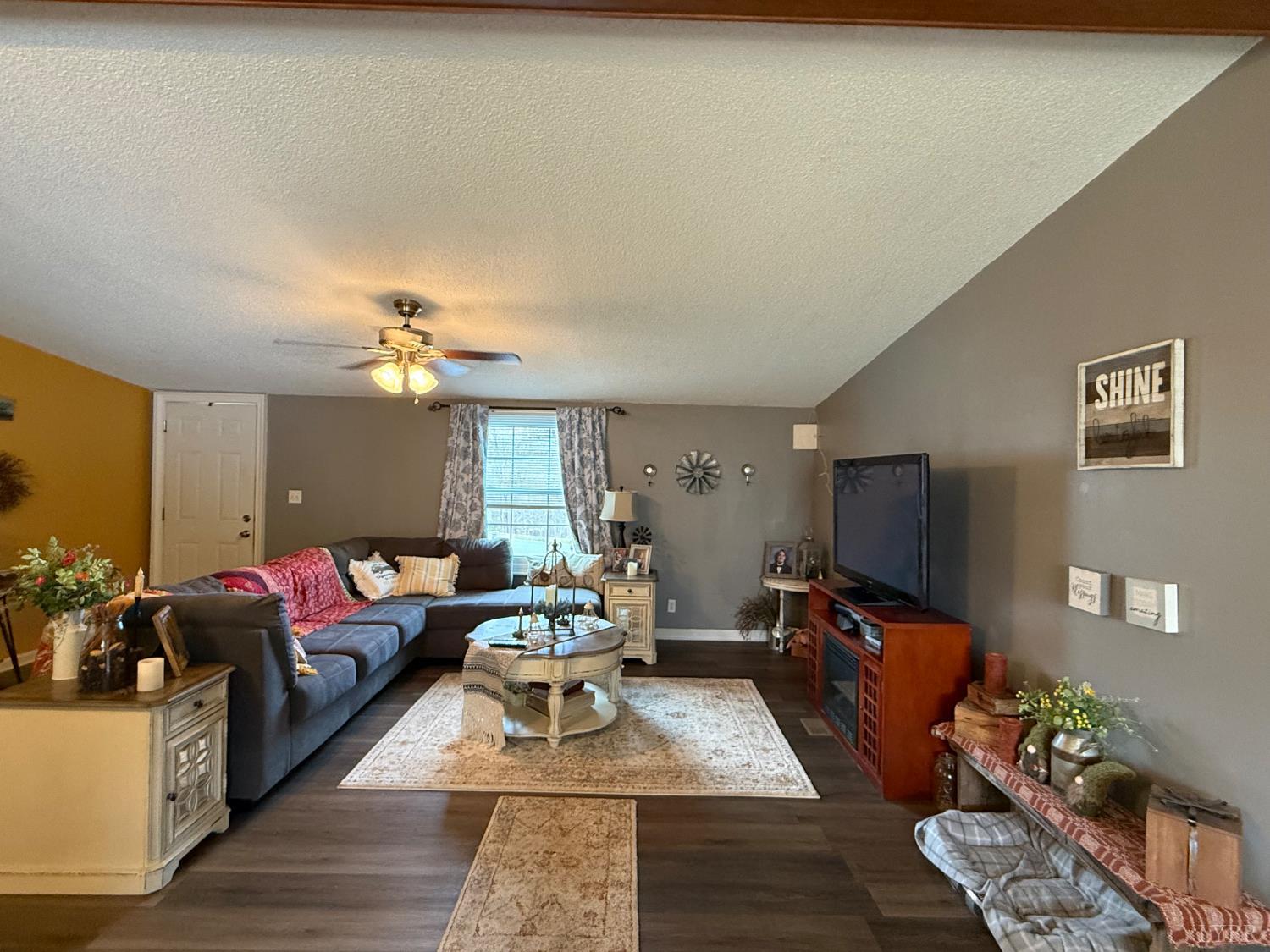 304 Plain Ridge Drive Evington, VA 24550 - Photo 11 of 16 a living room with furniture chandelier and a flat screen tv