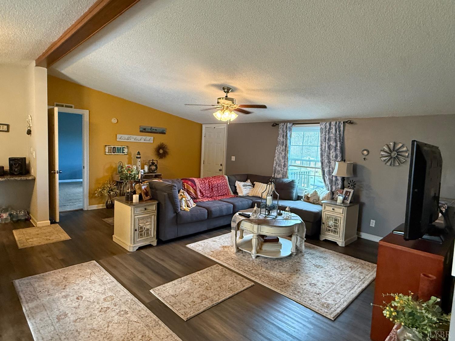 304 Plain Ridge Drive Evington, VA 24550 - Photo 13 of 16 a living room with furniture and a flat screen tv