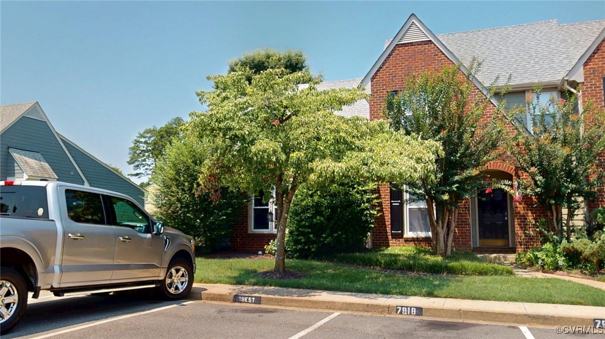 View of front of home featuring brick siding and u