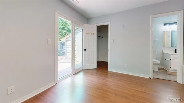 a view of a kitchen with a sink refrigerator and wooden floor