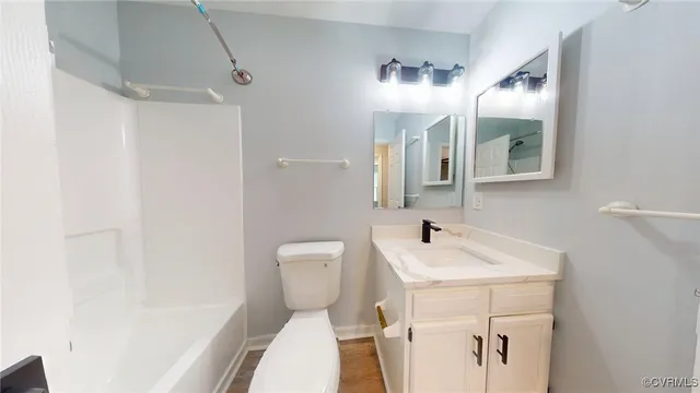 a white toilet sitting next to a bath tub
