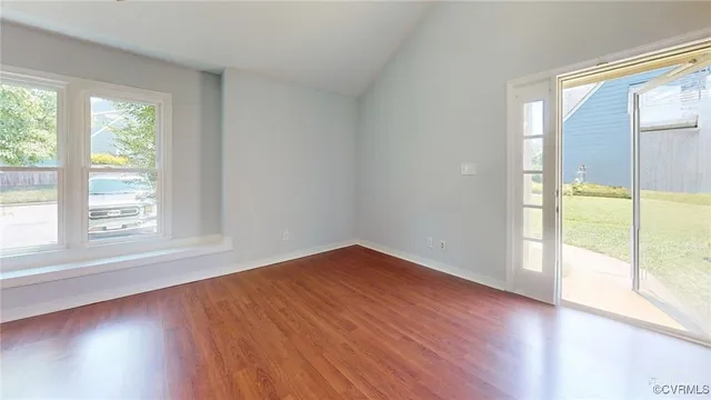 a view of an empty room with wooden floor